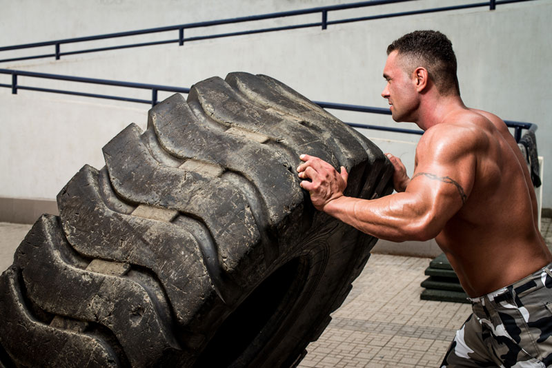 CrossFitters can be found flipping tires or hitting them with a sledgehammer, climbing ropes, and tossing medicine balls. (Shutterstock*)