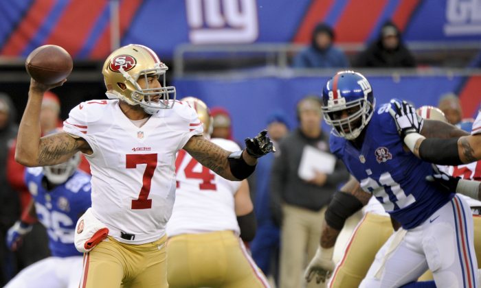 San Francisco 49ers quarterback Colin Kaepernick (7) throws a pass during the second half of an NFL football game against the New York Giants Sunday, Nov. 16, 2014, in East Rutherford, N.J.  (AP Photo/Bill Kostroun)