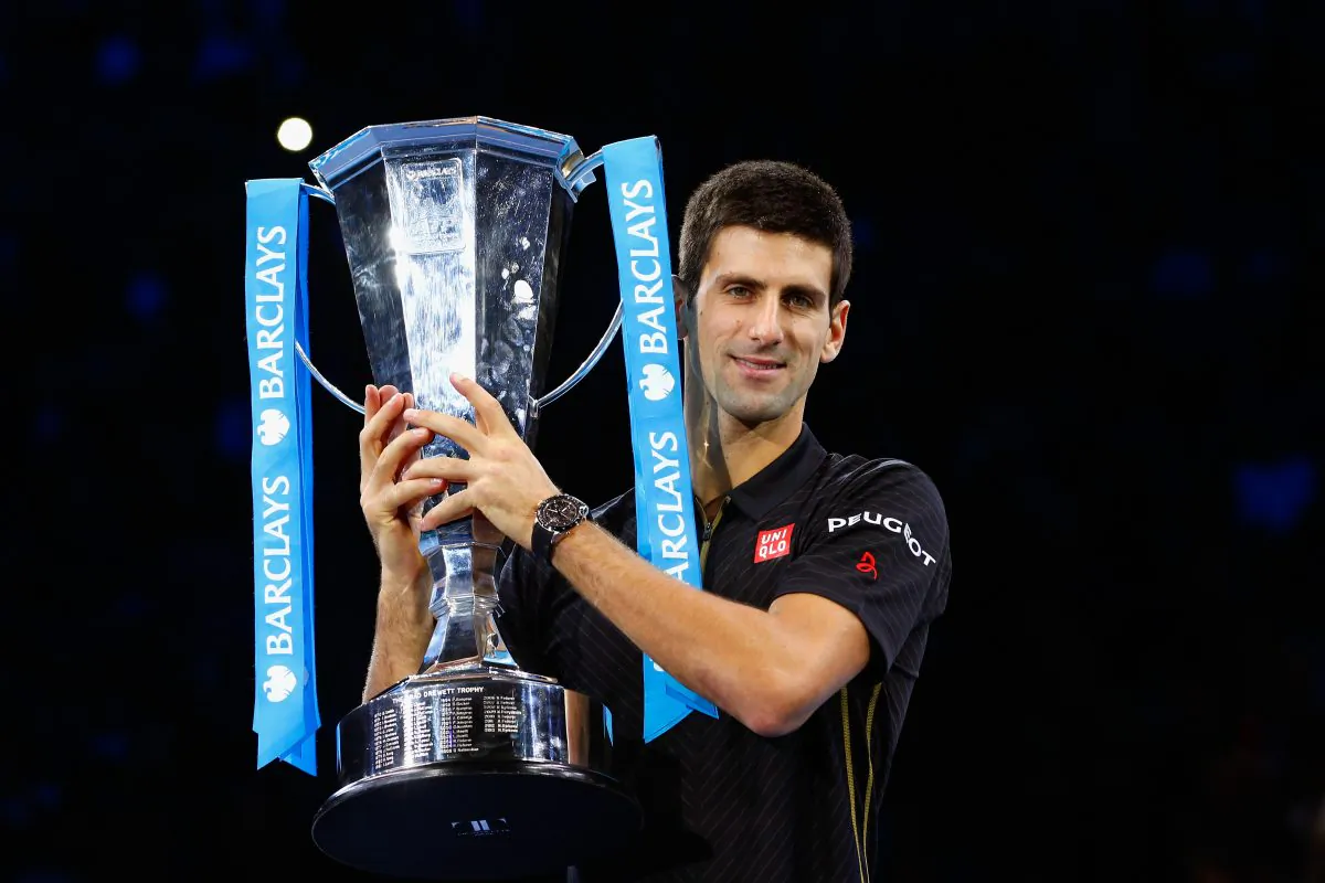 Image Caption: Novak Djokovic of Serbia poses with the ATP trophy on day eight of the Barclays ATP World Tour Finals at O2 Arena on November 16, 2014 in London, England. (Julian Finney/Getty Images)