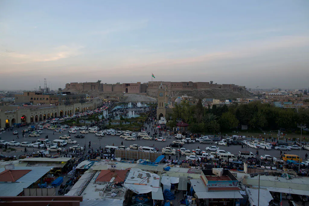 The Citadel of Irbil looms over downtown Irbil, 217 miles (350 kilometers) north of Baghdad, Iraq, on Nov. 13, 2014. The semi-autonomous Kurdish Regional Government has struggled to stabilize the local economy in the face of a militant onslaught and an expensive financial dispute with the Iraqi central government in Baghdad. (AP Photo/Bram Janssen)
