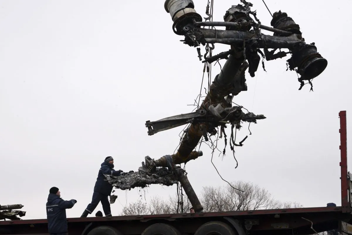 Recovery workers in rebel-controlled eastern Ukraine load debris from the crash site of Malaysia Airlines Flight 17, in Hrabove, Ukraine, Sunday, Nov. 16, 2014, four months after the plane was brought down.  (AP Photo/Mstyslav Chernov)