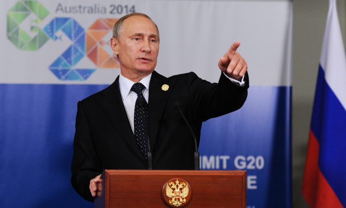 Russian President Vladimir Putin speaks to the media before departing from the G-20 summit in Brisbane, Australia, Nov. 15, 2014. Russian President Vladimir Putin made an early exit on Sunday from a two-day summit of world leaders where he was roundly criticized over Russia's escalating aggression in Ukraine, but brushed off suggestions that he had felt pressured. (AP Photo/RIA-Novosti, Mikhail Klimentyev, Presidential Press Service)