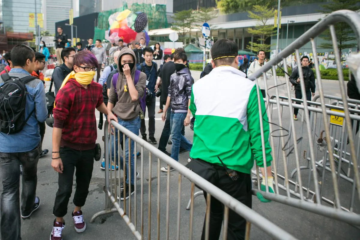 Protesters add more barricades to the area at the Citic Tower at Admiralty as police say they will clear the area after given the clearance from the high court in Hong Kong on Nov. 18, 2014. (Benjamin Chasteen/Epoch Times)