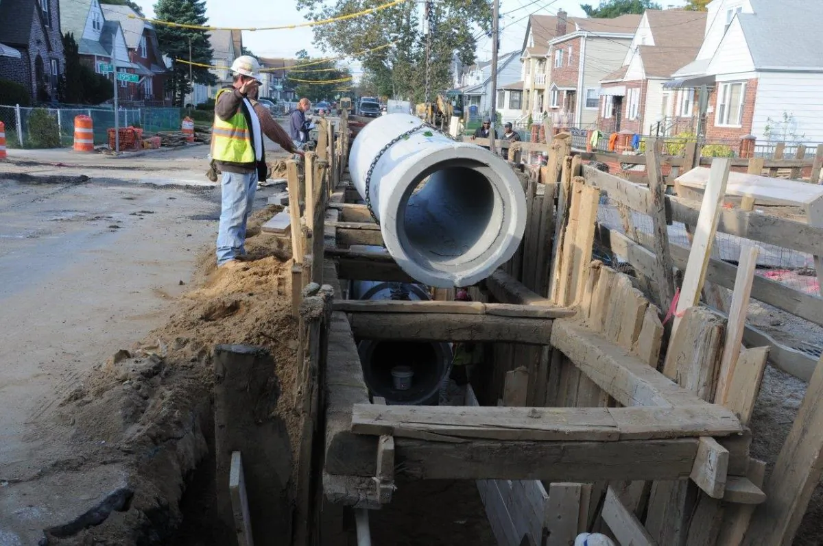 Workers install new water main pipe in the Queens neighborhood of Laurelton in New York City. Eighteen million dollars was pledged Monday by New York City’s Department of Environmental Protection for expanded water management. (Courtesy of NYC Environmental Protection)