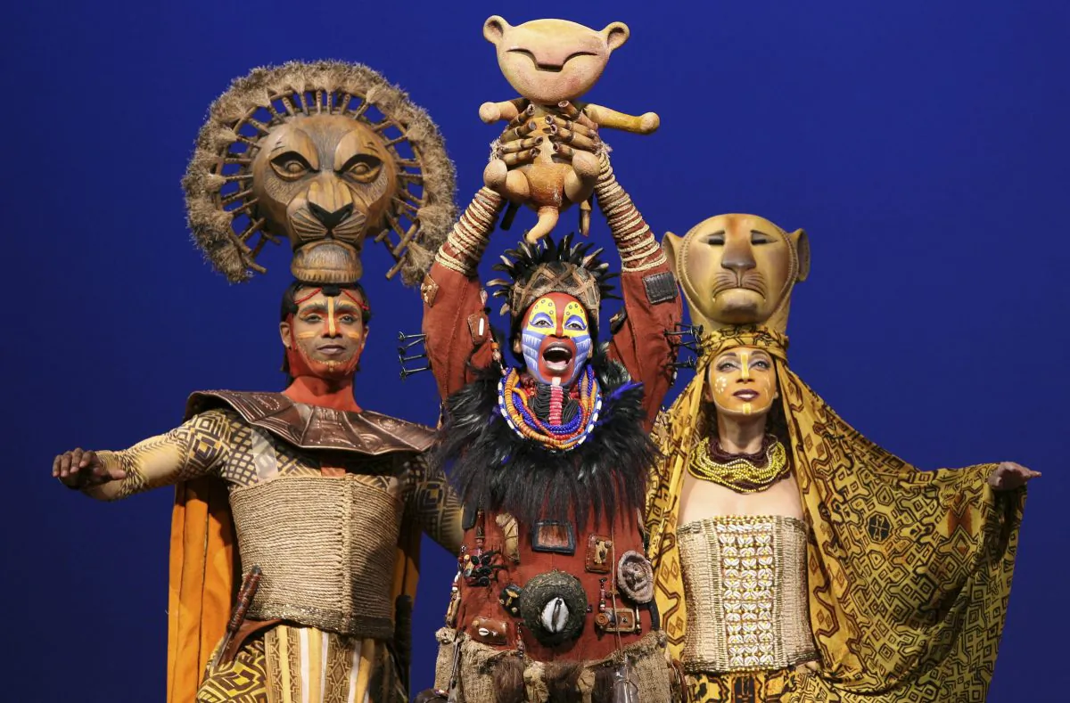 (L–R) Nathaniel Stampley as Mufasa, Tshidi Manye as Rafiki, and Jean Michelle Grier as Sarabi, in Disney's "The Lion King" in New York. Disney Theatrical Productions is letting ticketholders to its Broadway shows— “Aladdin” and “The Lion King”—the chance to switch the dates they see the musicals for any reason as long as it’s done two hours before the performance. (AP Photo/Disney Theatrical Group, Joan Marcus)