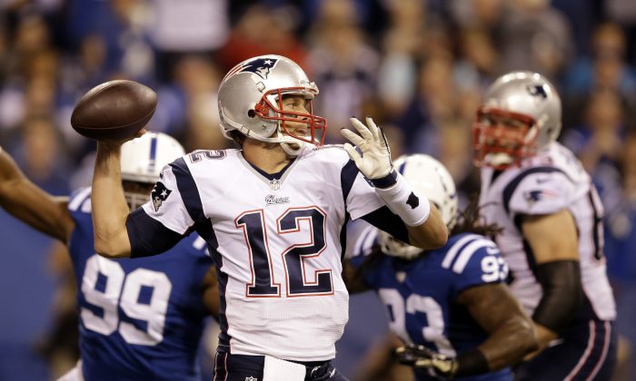 New England Patriots quarterback Tom Brady throws against the Indianapolis Colts during the first half of an NFL football game in Indianapolis, Sunday, Nov. 16, 2014. (AP Photo/Darron Cummings)