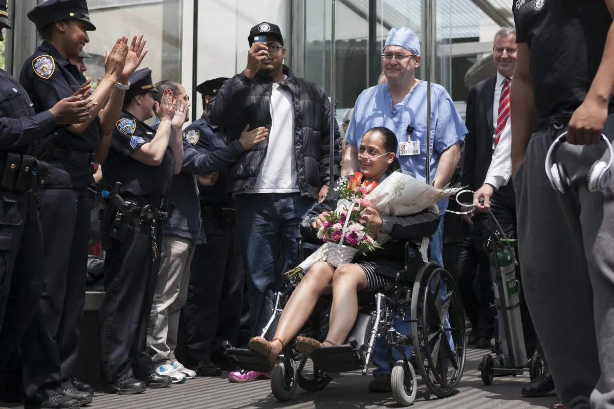 New York City police officer Rosa Rodriguez leaves the Weill Cornell Medical Center in Manhattan, New York on May 19, 2014, after recovering from a critical injury she suffered while responding to an apartment building fire. The city's police union is urging the City Council to support a state bill that would increase pensions for officers permanently injured while on duty. (Samira Bouaou/Epoch Times)