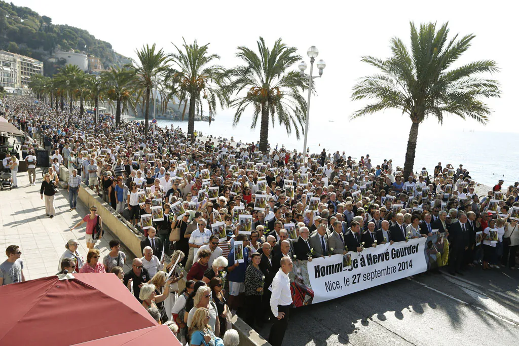 People pay tribute to mountain-guide Herve Gourdel, who was beheaded by Jihadists linked to the Islamic State group in Algeria, during a gathering in Nice, southeastern France, on Sept. 27, 2014. Jund al-Khilifa, or 'Soldiers of the Caliphate,' beheaded the 55-year-old Frenchman after he was abducted on September 21 while hiking in a national park that was once a magnet for tourists but later became a sanctuary for Islamists. (Valery Hache/AFP/Getty Images)