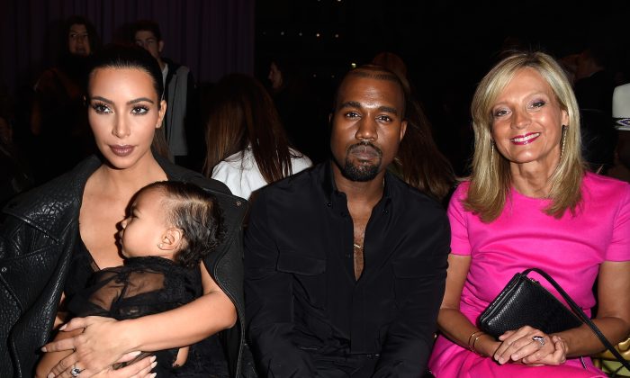 (L-R) Kim Kardashian, baby North West, Kanye West and Helene Arnault attend the Givenchy show as part of the Paris Fashion Week Womenswear Spring/Summer 2015 on September 28, 2014 in Paris, France. (Photo by Pascal Le Segretain/Getty Images)