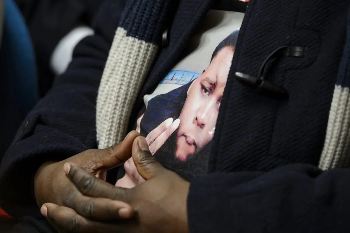 A portrait of Michael Brown, the unarmed black teenager who was shot and killed by a police officer in Ferguson, Missouri, last August, is worn by his father Michael Brown Sr. during a press conference on Nov. 12, 2014, in Geneva after a session of the United Nations Committee against Torture (CAT). The CAT committee members slammed police brutality that appears to disproportionately affect minorities. (Fabrice Coffrini/AFP/Getty Images)