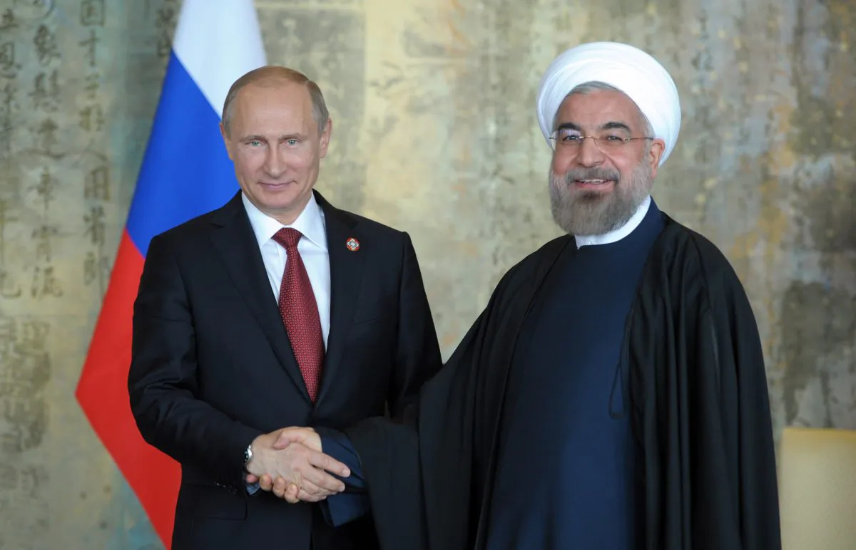 Russia's President Vladimir Putin (L) shakes with his Iran's counterpart Hassan Rouhani during their bilateral meeting in Shanghai on May 21, 2014. (Alexey Druzhinin/AFP/Getty Images)