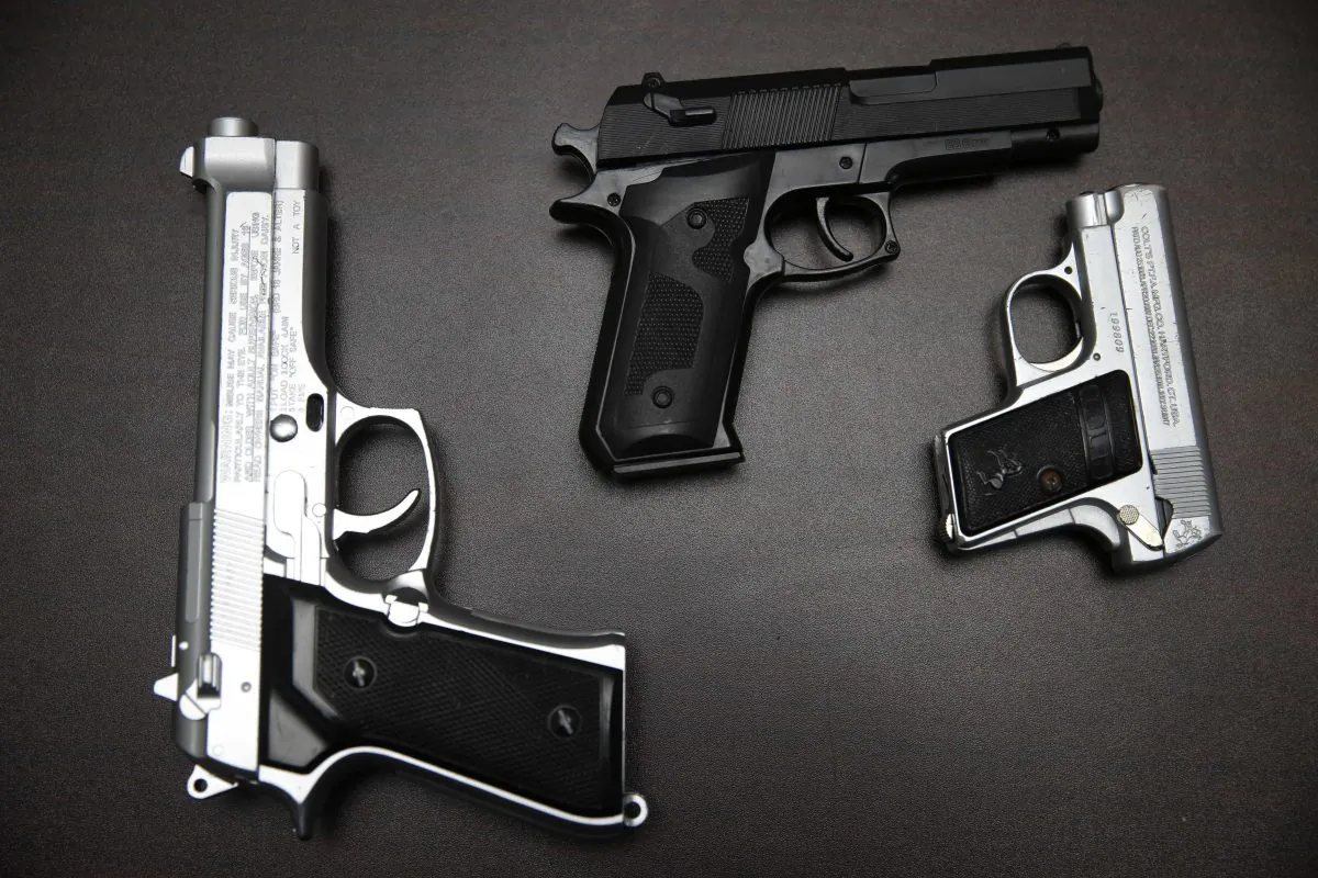 Fake guns are displayed with other prohibited carry-on items during a news conference at John. F. Kennedy Airport in New York, Tuesday, Nov. 18, 2014. The Transportation Security Administration displayed thousands of items on Tuesday that were confiscated from carry-on bags over three months at New York's Kennedy Airport. As the chaotic holiday travel season approaches, the agency wanted to remind the public what carry-on items were no-no's. (AP Photo/Seth Wenig)