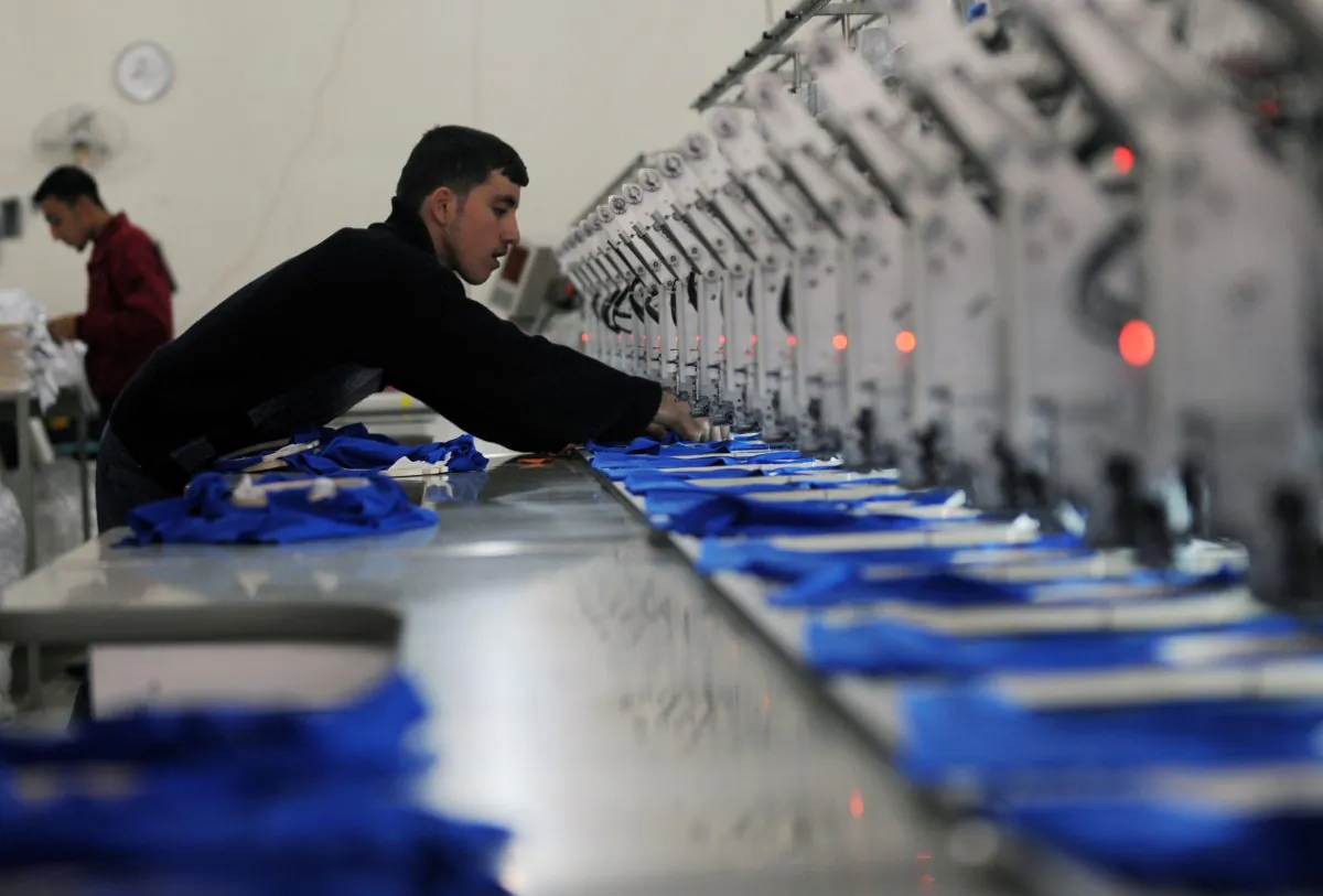A young Syrian man works at a clothes factory in the northern Syrian city of Aleppo on March 23, 2013. (Bulent Kilic/AFP/Getty Images)