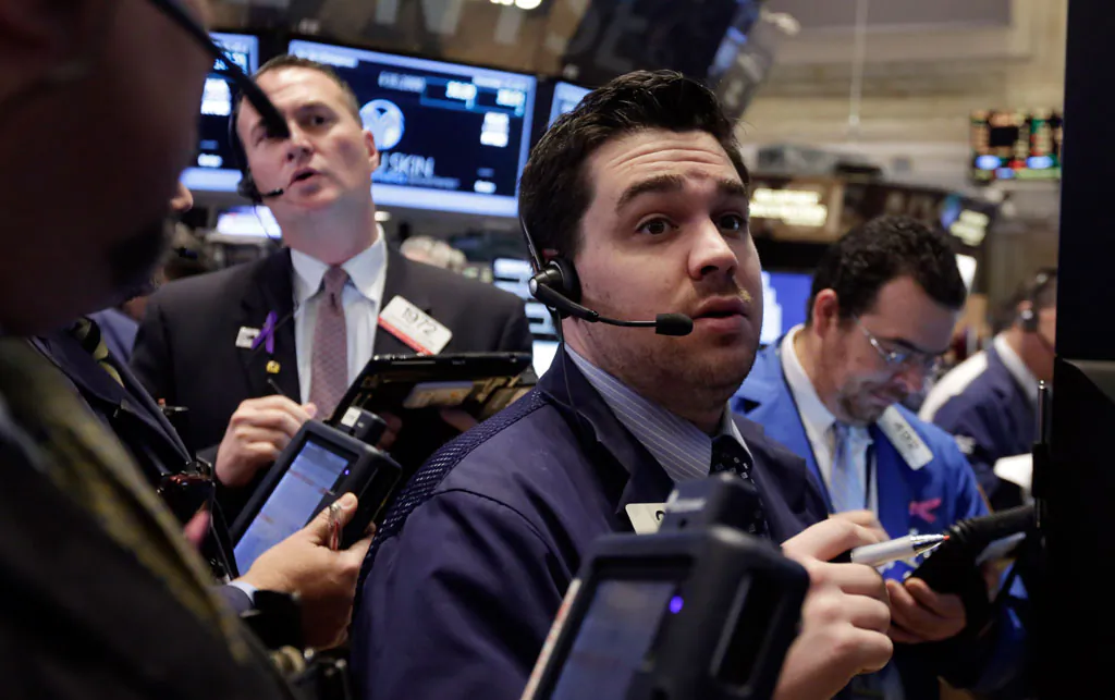 Traders gather at a post on the floor of the New York Stock Exchange, Tuesday, Nov. 18, 2014. Major US stocks opened higher on Tuesday, a day after the Standard & Poor's 500 index set its second record-high close in two days. (AP Photo/Richard Drew)