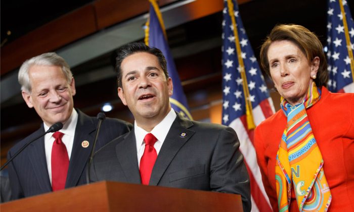 Rep. Ben Ray Lujan (D-N.M.) (C) thanks House Minority Leader Nancy Pelosi (D-Calif.) (R), after she announced he will take over as head of the Democratic Congressional Campaign Committee from Rep. Steve Israel (D-N.Y.) (L) during a news conference at the Capitol in Washington, on Nov. 17, 2014. (AP Photo)