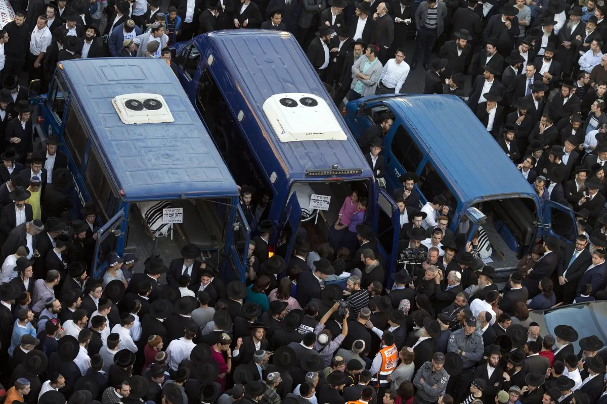 Orthodox Jews mourn over the bodies of three of the victims of an attack by two Palestinians on Jewish worshippers killing four Israelis at a synagogue in the Orthodox Har Nof neighbourhood in Jerusalem, at the site where the attack took place on Nov. 18, 2014. Two Palestinians armed with a gun and axes burst into a Jerusalem synagogue and killed four Israelis before being shot dead, in the deadliest attack in the city in years. (Gali Tibbon/AFP/Getty Images)
