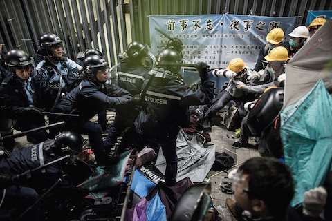 Police officers disperse pro-democracy protesters outside the Legislative Council building after clashes with pro-democracy activists on November 19, 2014 in Hong Kong. (Lam Yik Fei/Getty Images)