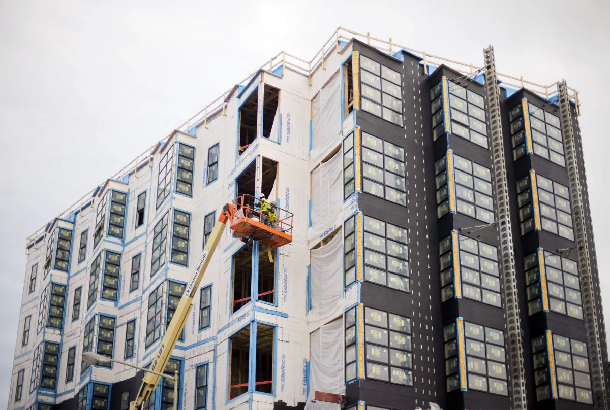 Construction continues on a boutique apartment building on the southeast corner of Florida Ave. and 14th Street NW, in Washington, on Nov. 4, 2014. Construction of new homes fell slightly in October after a big surge in the previous month, the Commerce Department reported Wednesday, Nov. 19, 2014, but the weakness was largely driven by the volatile apartment sector. (AP Photo/Pablo Martinez Monsivais)