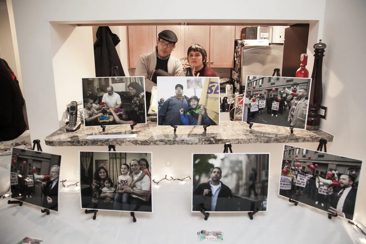 People at a pop-up exhibit on the lives of building workers in Chelsea, hosted at Lowell Kern's apartment at 520 W 23rd Street, on Nov. 18, 2014. (Samira Bouaou/Epoch Times)