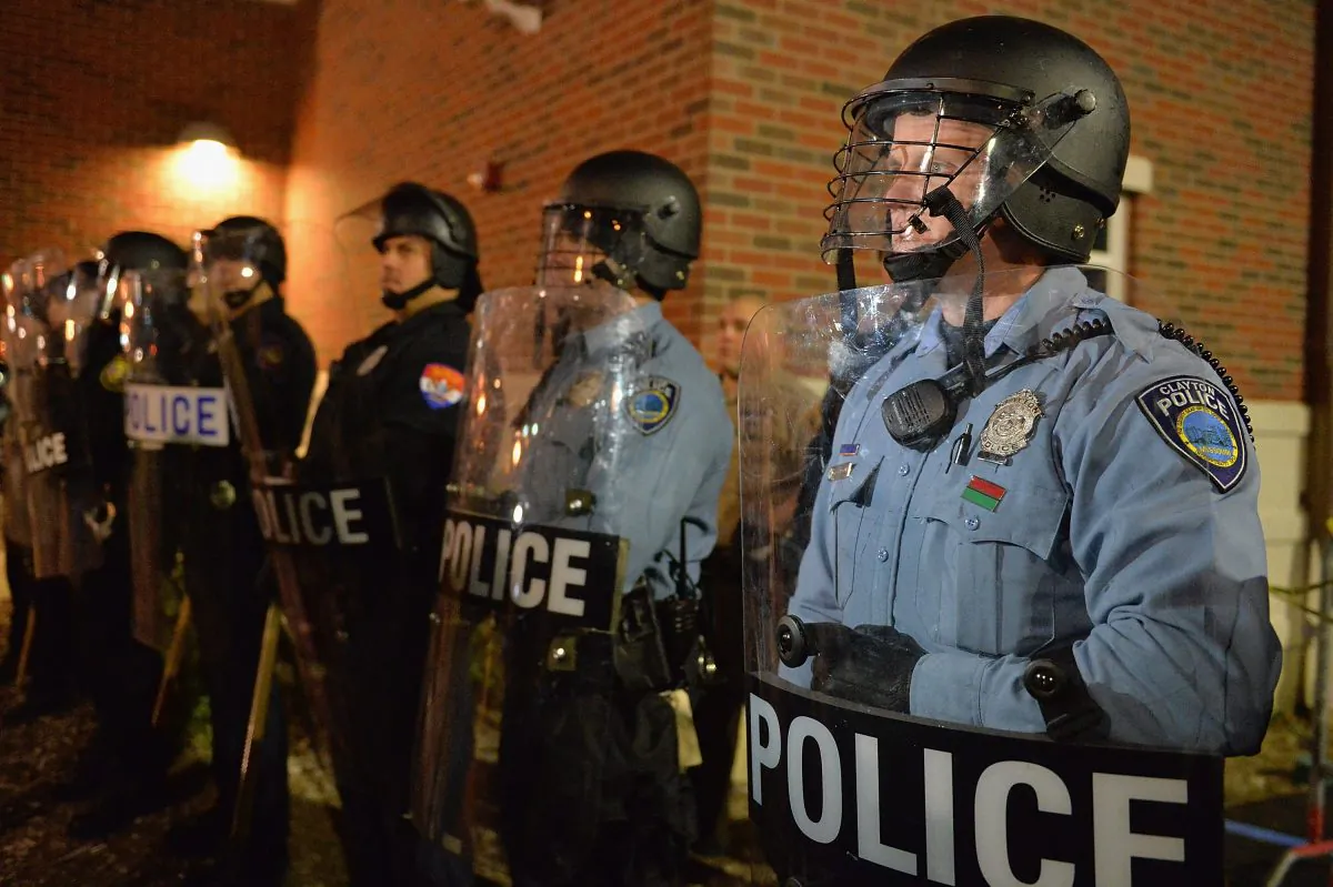 Police officers stand in riot gear during a protest on Nov. 19, 2014, outside the Ferguson Police Department in Ferguson, MO. (Michael B. Thomas/AFP/Getty Images)