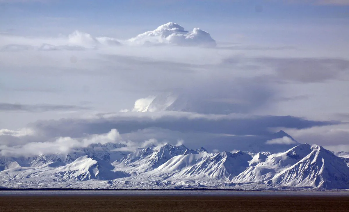 Mount Redoubt bellows steam as seen from Kenai, Alaska Thursday, March 26, 2009. The volcano on the west side of Cook Inlet erupted Thursday morning sending ash clouds an estimated 65,000 feet into the air and is expected to affect the towns of Kenai and Homer. (AP Photo/Al Grillo)