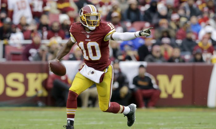 Washington Redskins quarterback Robert Griffin III (10) scrambles with the ball during the second half of an NFL football game against the Tampa Bay Buccaneers in Landover, Md., Sunday, Nov. 16, 2014. (AP Photo/Patrick Semansky)