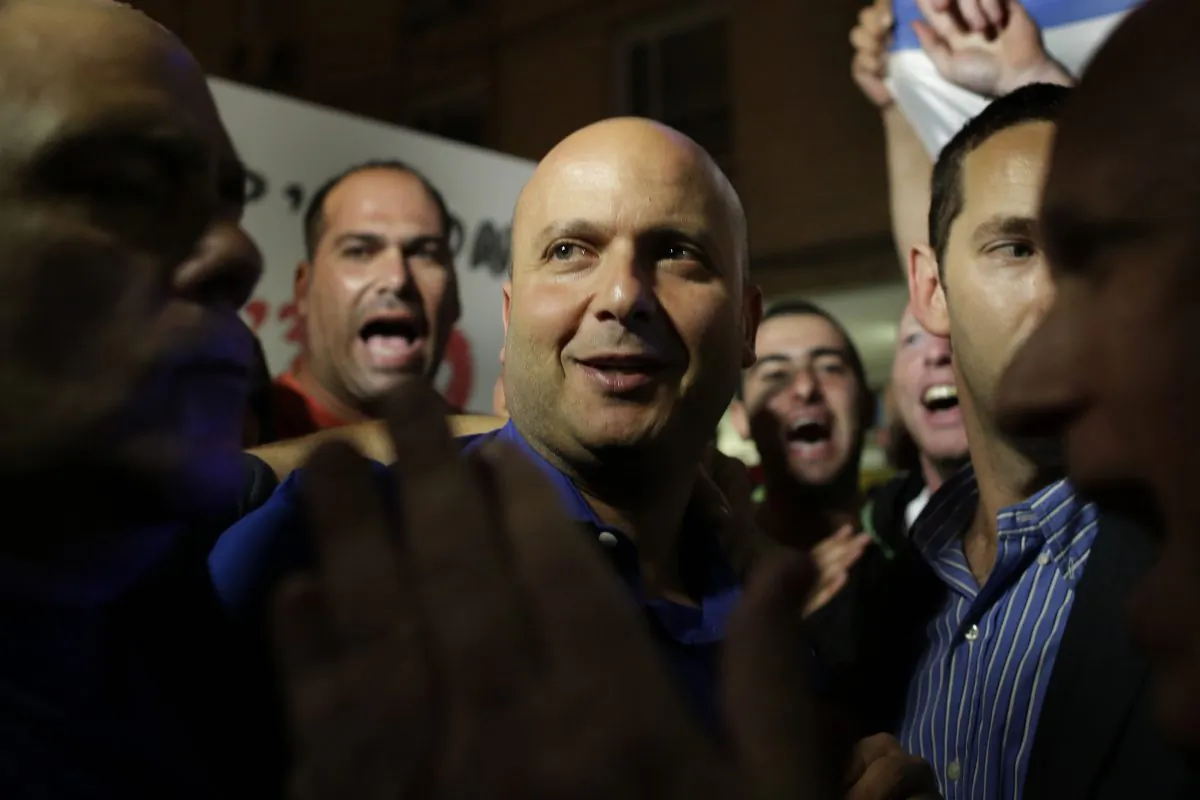 Israeli mayor of the costal city of Ashkelon Itamar Shimoni joins a rally in his support in Ashkelon, Israel, Thursday, Nov. 20, 2014. Shimoni has suspended Israeli Arab laborers from work, renovating bomb shelters at local day-care centers. The move drew widespread criticism on Thursday, including from Netanyahu who said "there is no place for discrimination against Israeli Arabs." (AP Photo/Tsafrir Abayov)