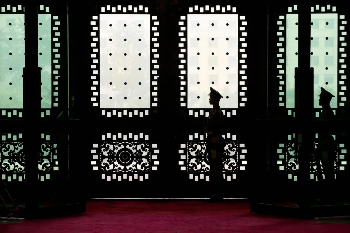 Chinese soldiers stand guard in the Chinese Defense Ministry's Bayi Building in Beijing on Sept. 9, 2013. An estimated 250,000 to 300,000 Chinese soldiers are involved in hacking the computers of other nations' governments and businesses. (Alexander F. Yuan-Pool/Getty Images)