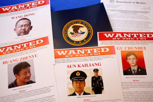 FBI material showing five Chinese military officers wanted on charges of economic espionage and trade secret theft are shown at the Justice Department in Washington, on May 19. The indictment of these five represents a first step for U.S. efforts to hold accountable the Chinese military for the theft of U.S. intellectual property and classified information. (AP Photo/Charles Dharapak)