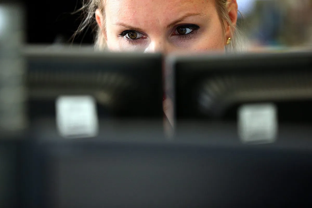 An employee views trading screens at the offices of Panmure Gordon and Co on Oct. 20, 2014 in London, England. (Carl Court/Getty Images)