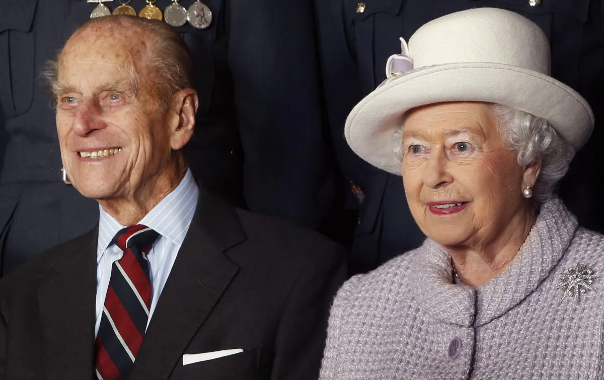 Prince Philip, Duke of Edinburgh and Queen Elizabeth II pose for a photo during a visit to RAF Lossiemouth on their 67th wedding anniversary on November 20, 2014 in Lossiemouth, Scotland. It was the Queen's first visit to the base since 2003. (Photo by Danny Lawson - WPA Pool/Getty Images)