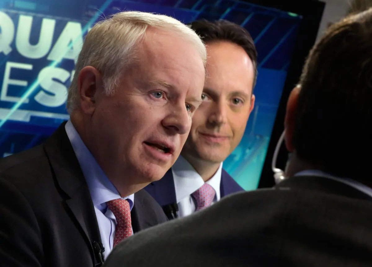 Allergan CEO David Pyott (L) and Actavis CEO Brenton Saunders are interviewed on the floor of the New York Stock Exchange, on Nov. 17, 2014. Pyott is set to rake in an estimated $100 million in golden parachute payments, according to a study done by pay-tracking firm Equilar at the request of The Associated Press. (AP Photo/Richard Drew)