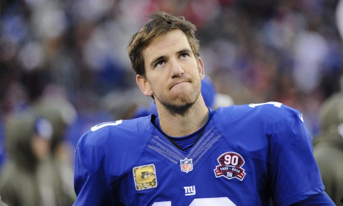 New York Giants quarterback Eli Manning (10) reacts during the second half of an NFL football game against the San Francisco 49ers Sunday, Nov. 16, 2014, in East Rutherford, N.J. The 49ers won the game 16-10. (AP Photo/Bill Kostroun)