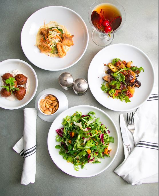 (Clockwise) Skate Bites with Napa cabbage-poblano slaw and jalapeño mayo; Manhattan; Octopus, with confit potato, dried tomato, Meyer lemon, and mustard oil; Fall Salad; smoked almonds; Lentil Fritters, with cucumber-lime yogurt. (Samira Bouaou/Epoch Times)