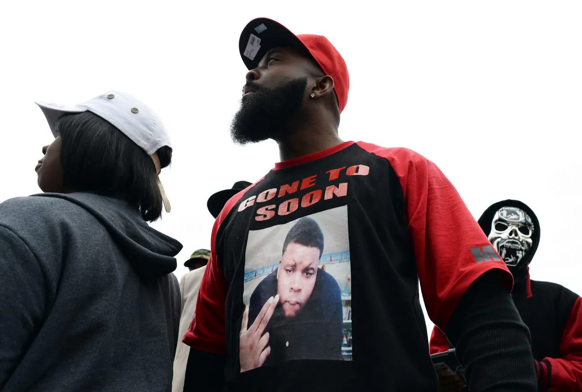 Michael Brown Sr. (C), the father of 18-year-old Michael Brown who was shot dead by a police officer, speaks to neighbors as he distributes turkey for Thanksgiving where his son was killed in Ferguson, Missouri, on Nov. 22, 2014. (Jewel Samad/AFP/Getty Images)