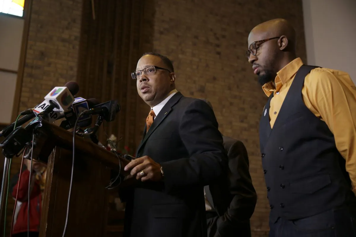 Anthony Gray, attorney for the family of Michael Brown, speaks as National Action Network Ferguson chapter president Rev. Carlton Lee (R) listens during a news conference Friday, Nov. 21, 2014, in St. Louis County, Mo. Gray and Lee spoke about preparations as citizens wait for a decision from the grand jury whether to indict Ferguson police officer Darren Wilson in the shooting of Michael Brown. (AP Photo/Jeff Roberson)