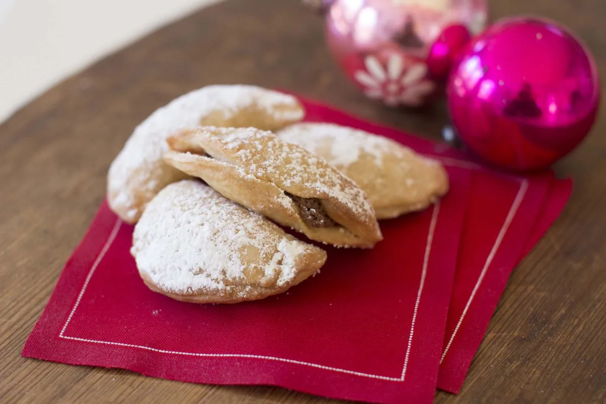 Chocolate almond crescent cookies are a healthy holiday treat, using almonds and coconut oil for fat and maple syrup as a sweetener. A light dusting of confectioners’ sugar covers the top of the cookies. (AP Photo/Matthew Mead)