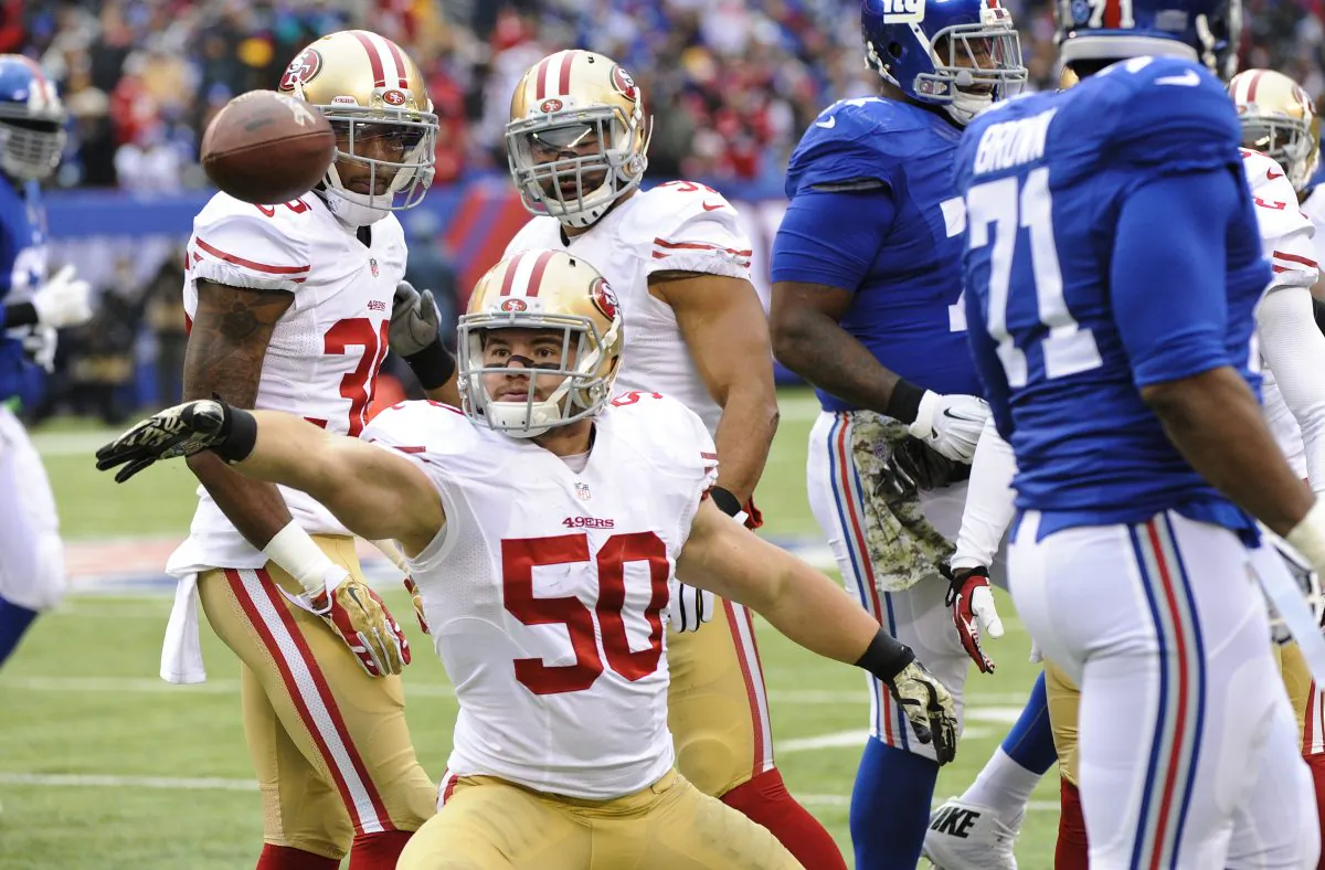 San Francisco 49ers inside linebacker Chris Borland (50) celebrates after intercepting a pass during the first half of an NFL football game against the New York Giants in East Rutherford, N.J., Nov. 16, 2014. (AP Photo/Bill Kostroun)