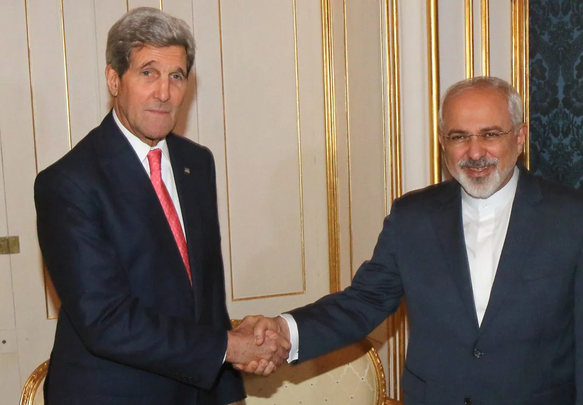 U.S. Secretary of State John Kerry shakes hands with Iranian Foreign Minister Mohammad Javad Zarif, right, prior to a bilateral meeting of the closed-door nuclear talks with Iran in Vienna, Austria, Sunday, Nov. 23, 2014. (AP Photo/Ronald Zak)