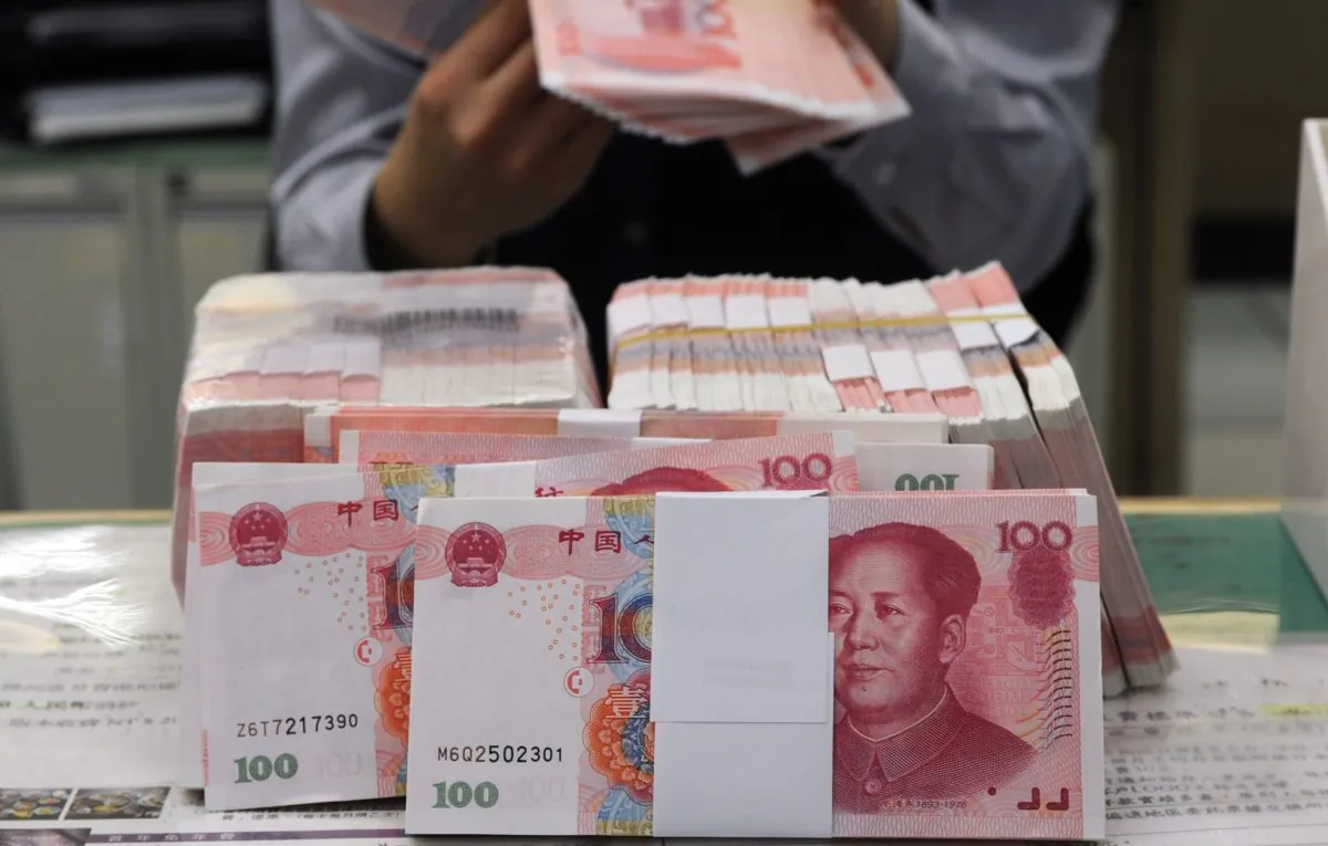 Chinese yuan banknotes at a bank in Taipei, Taiwan, on Feb. 6, 2013. For decades, China's income tax laws have exacerbated the wealth gap in China by discriminating against low-income groups. (Sam Yeh/AFP/Getty Images)