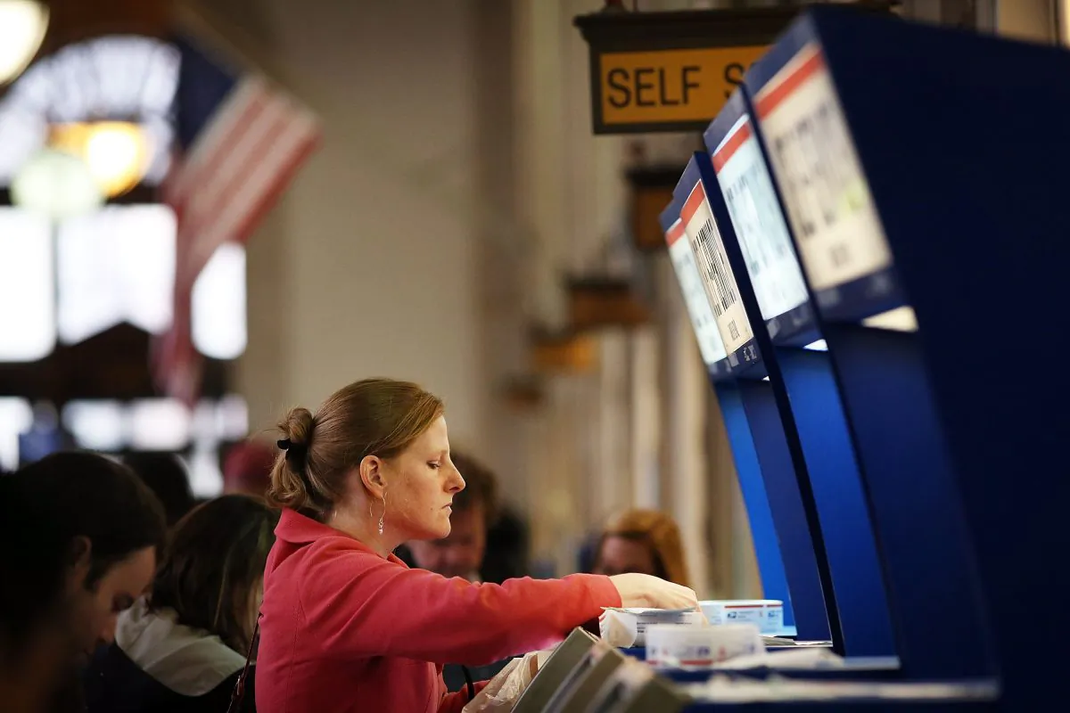A woman sends mail to file taxes, at the James A. Farley post office in Manhattan, New York City, on April 15, 2014. (Spencer Platt/Getty Images)
