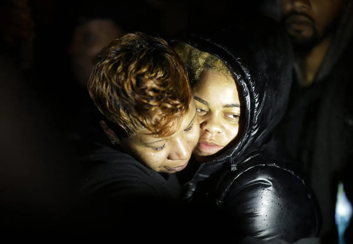 Lesley McSpadden (L), the mother of Michael Brown, embraces a supporter during a demonstration at the memorial near where the black teen was shot and killed by a white policeman more than three months ago, Saturday, Nov. 22, 2014, in Ferguson, Mo. (AP Photo/David Goldman)