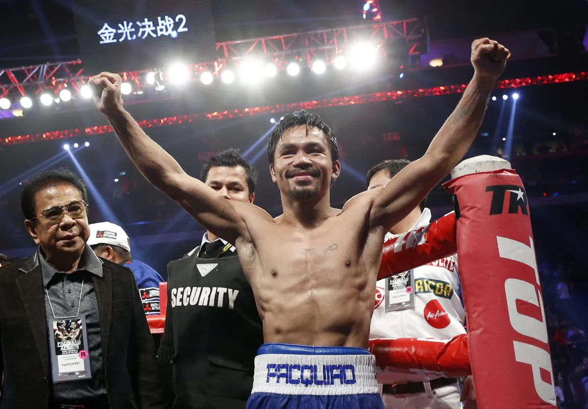 WBO welterweight champion Manny Pacquiao celebrates after defeating WBO junior welterweight champion Chris Algieri of the U.S. during their welterweight title boxing match at the Venetian Macao in Macau, Sunday, Nov. 23, 2014. (AP Photo/Kin Cheung)