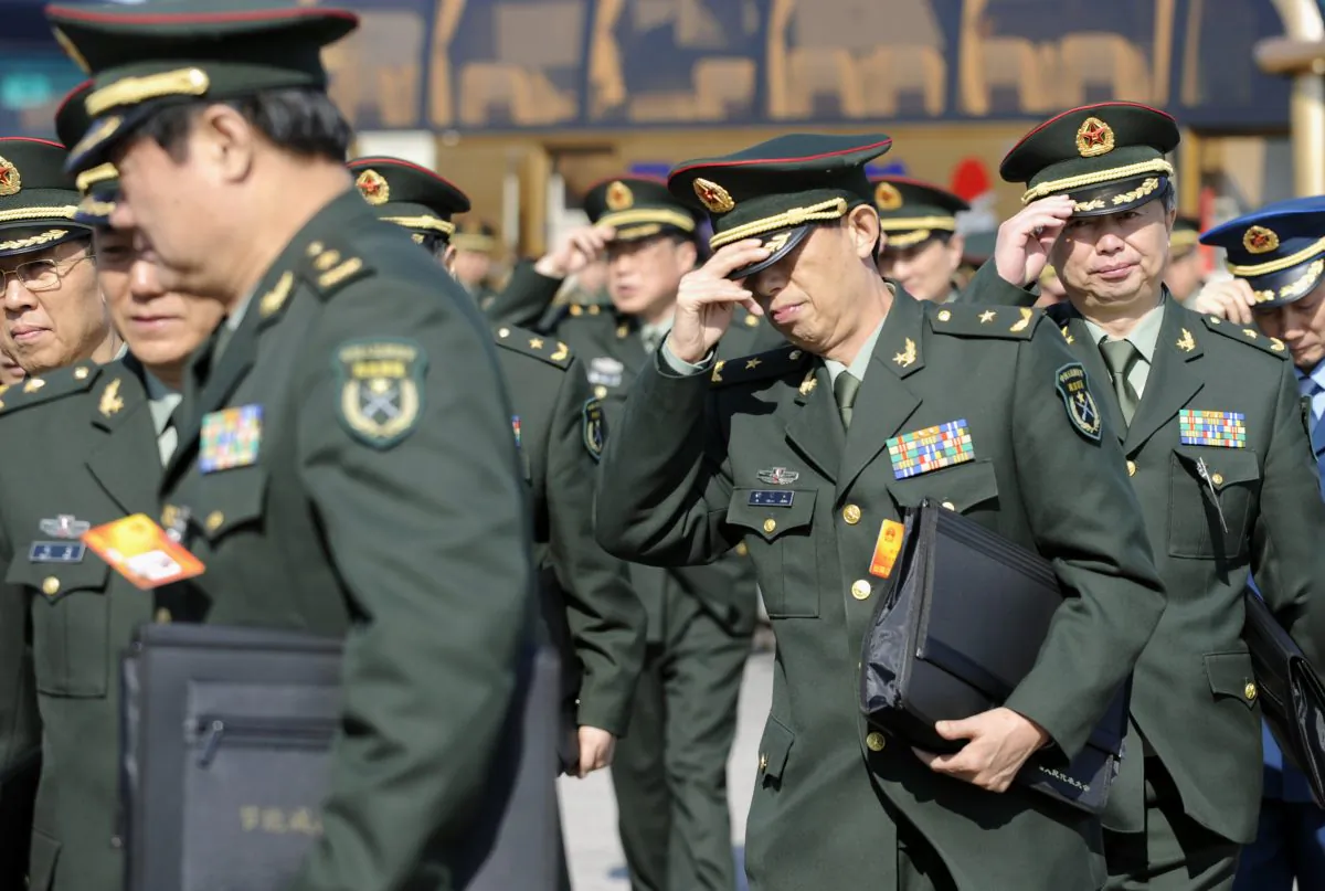 Chinese military delegates arrive for a plenary session of the National People's Congress in Beijing on March 9, 2010. (Liu Jin/AFP/Getty Images)