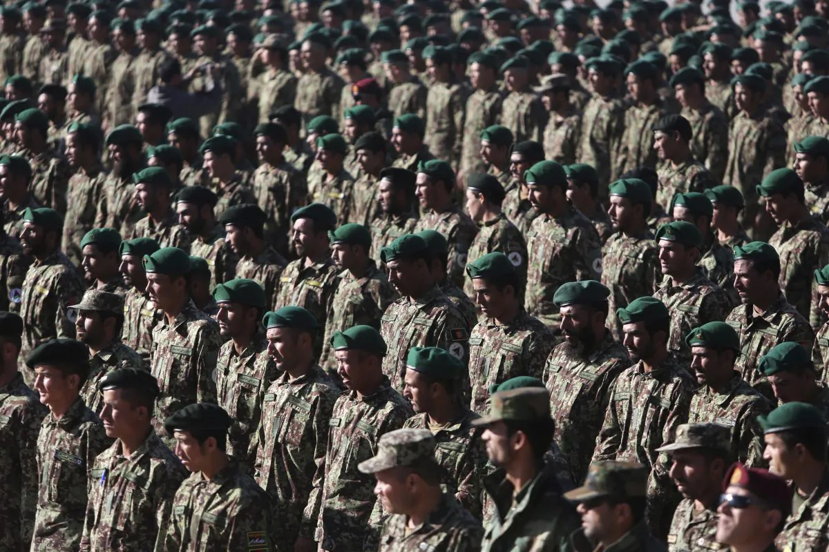 New members of the Afghan National Army attend their graduation ceremony at the Afghan Military Academy in Kabul, Afghanistan, Sunday, Nov. 23, 2014. Afghanistan's parliament approved agreements Sunday with the U.S. and NATO allowing international troops to remain in the country past the end of this year amid a renewed offensive by Taliban militants. The international combat mission in Afghanistan, begun after the 2001 U.S.-led invasion that toppled the Taliban, was to conclude at the end of this year. The new agreements ratified by parliament allow the U.S. and NATO to keep a total of 12,000 troops in Afghanistan next year to support local forces. (AP Photo/Rahmat Gul)