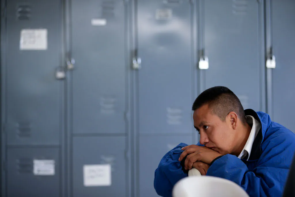 Cuauhtemoc Martinez looks on as he waits for information on his birth records at the Padre Chava migrant shelter Wednesday, Nov. 19, 2014, in Tijuana, Mexico. Recently deported from Salt Lake City, Martinez has struggled to track down any records of his birth in Mexico, which he needs for identification and to apply for jobs in Mexico. (AP Photo/Gregory Bull)