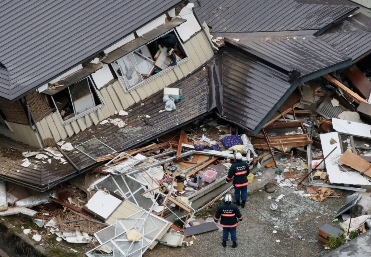This aerial photo shows collapsed houses after a strong earthquake hit Hakuba, Nagano prefecture, central Japan, Sunday, Nov. 23, 2014. The magnitude-6.7 earthquake shook on Saturday night the mountainous area that hosted the 1998 Winter Olympics destroying more than half a dozen homes in the ski resort town. (AP Photo/Kyodo News)