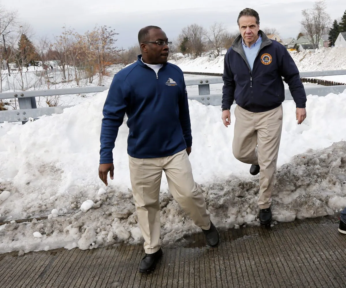 New York Gov. Andrew Cuomo, right, and Buffalo Mayor Byron Brown survey storm clean-up near Cazenovia Creek in the south Buffalo, N.Y. area on Sunday, Nov. 23, 2014. Western New York continues to dig out from the heavy snow dropped this week by lake-effect snowstorms. (AP Photo/Mike Groll)
