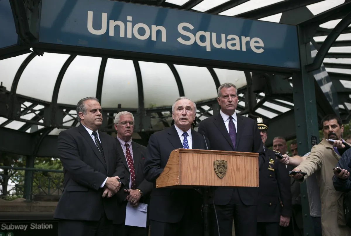 New York City Mayor Bill de Blasio (R) and New York City Police Commissioner William Bratton (C) at a press conference held in front of the Union Square subway station in New York on Sept. 25, 2014. (Samira Bouaou/Epoch Times)