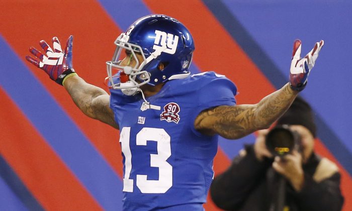 New York Giants wide receiver Odell Beckham Jr. (13) reacts after making a one-handed catch for a touchdown against the Dallas Cowboys in the first quarter of an NFL football game, Sunday, Nov. 23, 2014, in East Rutherford, N.J. (AP Photo/Kathy Willens)